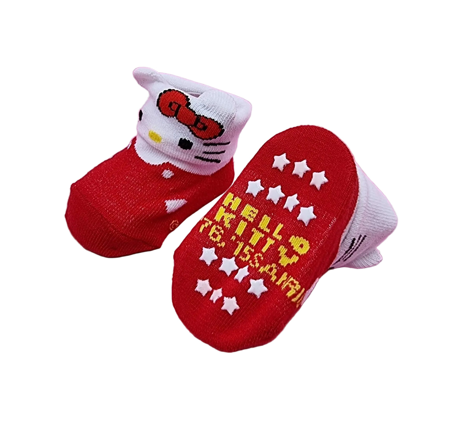 A pair of Hello Kitty baby socks on a pink background, featuring a red and white color scheme with embroidered Hello Kitty face details and yellow text on the sole.
