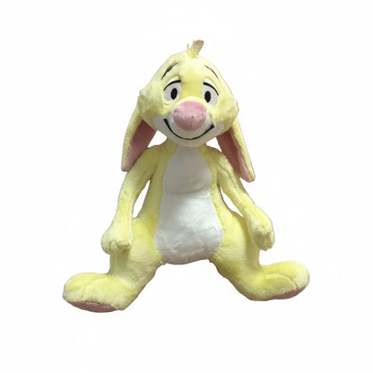 Plush toy resembling a cartoon character held by a person, with a Disney Store authenticity stamp in the corner.